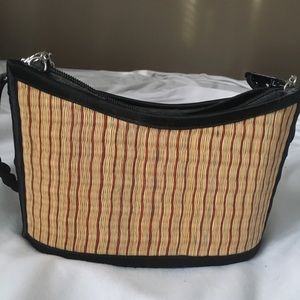 Straw pocketbook with braided straps.